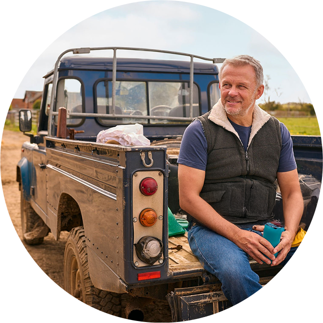 Farmer sitting in the back of truck